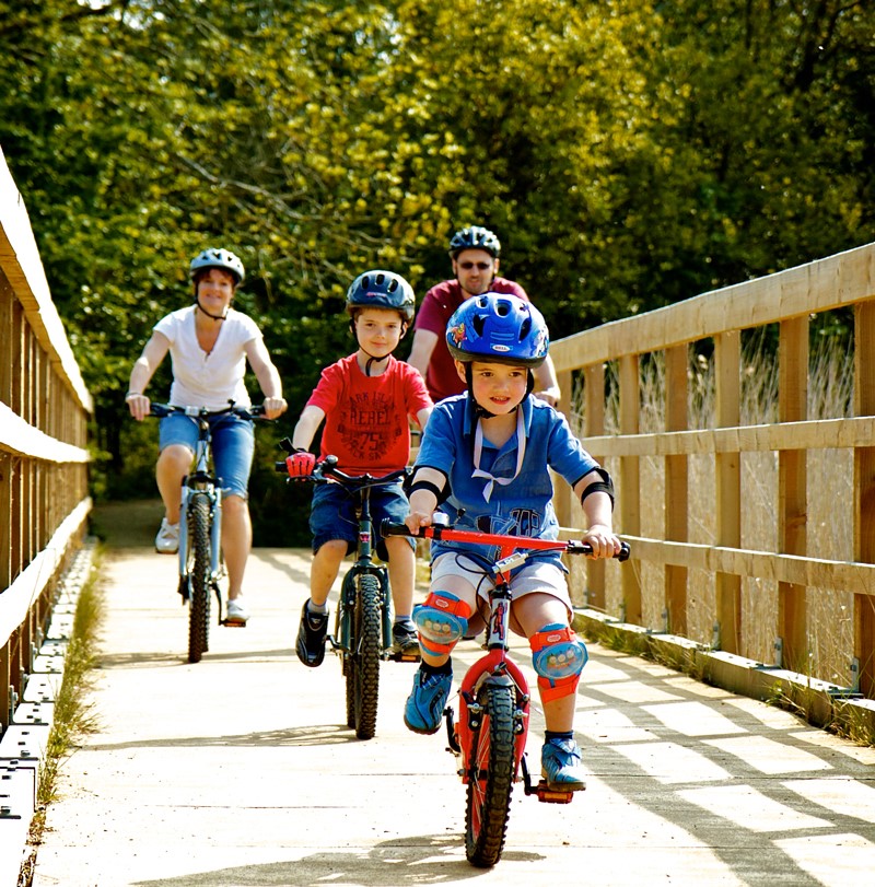 Family enjoying a bike ride in the sunshine at Poole