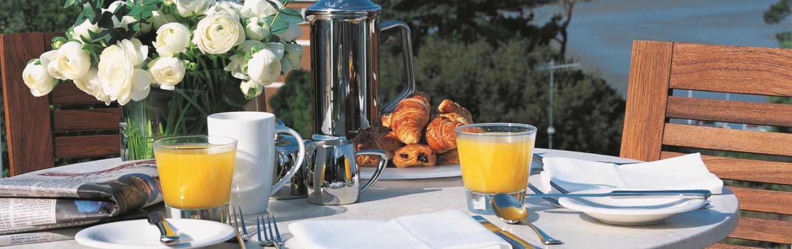 Tasty Breakfast set up on a table next to the seaside