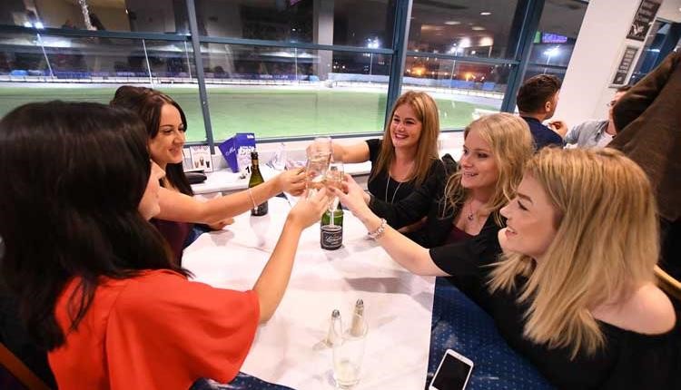 Group of friends toasting at the Poole Greyhound races 