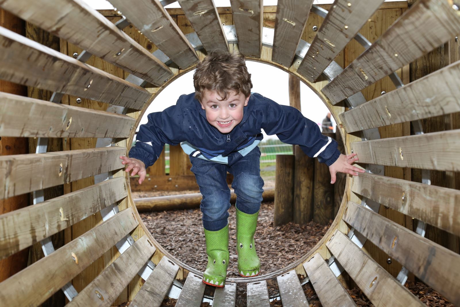 A little boy playing on Upton Park's new treehouse play area
